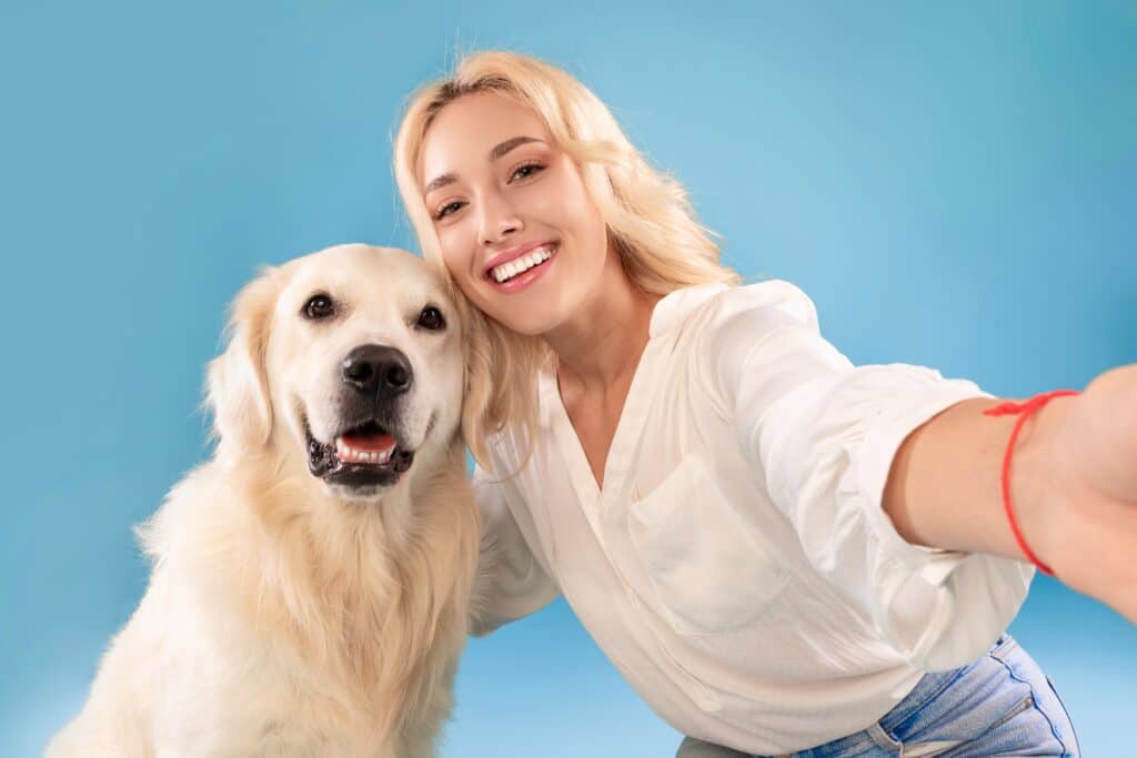 Owner With Dog Having A Studio Photoshoot